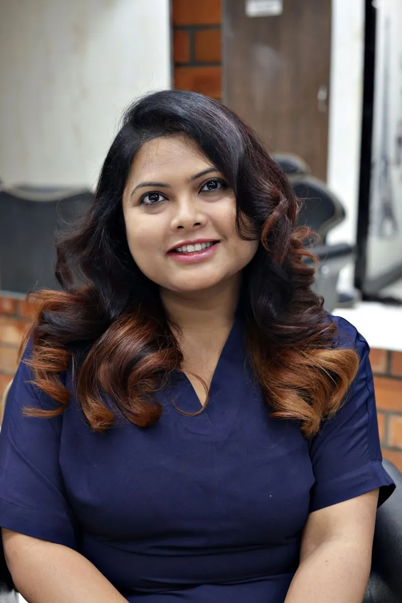 Woman smiling in a salon with freshly styled hair