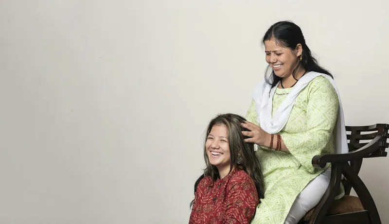 Stylist doing a laughing customer's hair